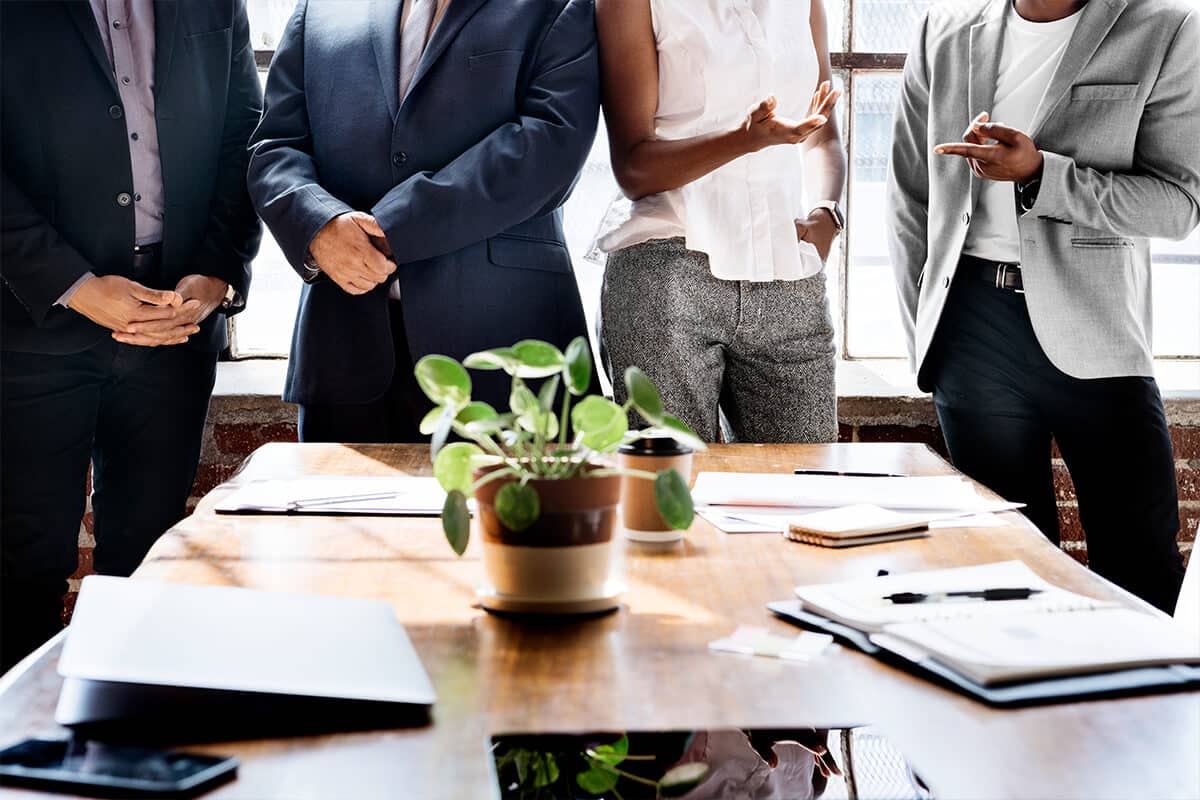 A group of people standing around a table.